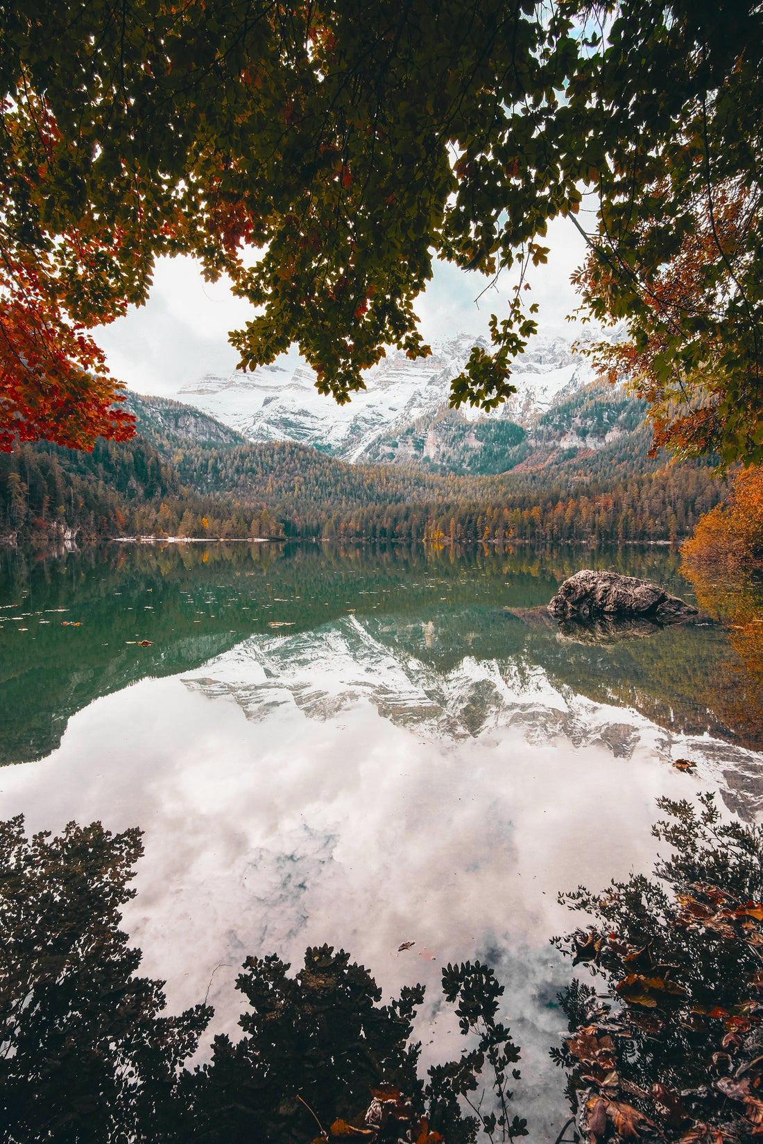 Snow-covered mountains reflecting on water by fall forest - Christ's authority over nature Matthew 8:1-17