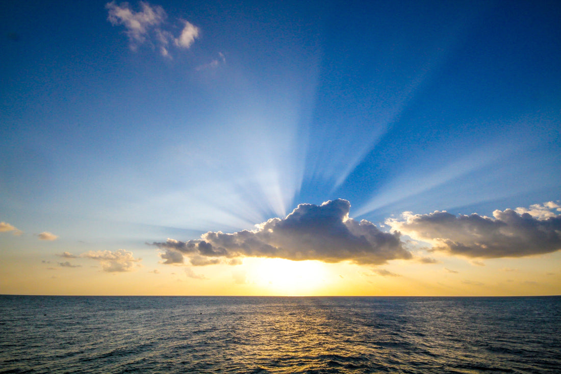 Sunset over ocean symbolizing God's transcendence and glory in Isaiah 66
